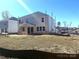 Spacious backyard view of new home construction, awaiting landscaping and personal touches under a clear sky at 9957 Cask Way, Huntersville, NC 28078