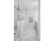 Bright bathroom with a glass-enclosed shower, marble tile and modern fixtures at 9957 Cask Way, Huntersville, NC 28078