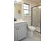 Bathroom featuring white cabinets, and a shower with a black frame and marble tiling at 9957 Cask Way, Huntersville, NC 28078