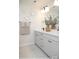 Bathroom featuring double vanity with gray cabinets, modern black fixtures, and decorative wall accents at 9957 Cask Way, Huntersville, NC 28078