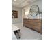 Well-lit bedroom with large dresser, round mirror, and decorative art piece above the dresser at 9957 Cask Way, Huntersville, NC 28078