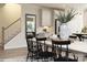 Bright dining area features a farmhouse table and black chairs near kitchen at 9957 Cask Way, Huntersville, NC 28078