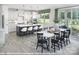 Open-concept kitchen and dining area with a large island, modern appliances, and seamless access to outdoor living at 9957 Cask Way, Huntersville, NC 28078