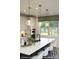 Modern kitchen island with quartz countertops and stylish pendant lighting at 9957 Cask Way, Huntersville, NC 28078