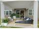 Covered patio with neutral furniture, sliding glass doors, and views of the green backyard at 9957 Cask Way, Huntersville, NC 28078