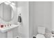 Clean bathroom with pedestal sink, toilet and an elegant mirror at 1037 Tobin Dr, Fort Mill, SC 29715