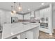 Open concept kitchen island with white cabinets and stainless steel appliances at 1037 Tobin Dr, Fort Mill, SC 29715