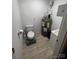 Small bathroom with toilet, sink, and water heater at 108 Greenview Dr, Kannapolis, NC 28081