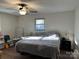 Main bedroom with a king-size bed, ceiling fan, and ample storage at 108 Greenview Dr, Kannapolis, NC 28081