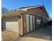 Attached garage with white door and brick exterior at 108 Greenview Dr, Kannapolis, NC 28081