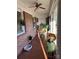 Sunroom with terracotta tile floor, wicker chair, and plants at 108 Greenview Dr, Kannapolis, NC 28081