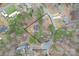 Aerial view of the property with a fenced in backyard situated on a wooded lot at 114 Catawba Woods Ct, Belmont, NC 28012