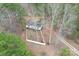 Aerial view of property with mature trees and white picket fence provides privacy at 114 Catawba Woods Ct, Belmont, NC 28012