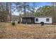 Rear exterior of house, with a small porch, surrounded by a spacious yard and mature trees at 114 Catawba Woods Ct, Belmont, NC 28012