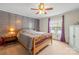 Bright bedroom with wood accent wall, ceiling fan, window, and modern furnishings, offering cozy vibes at 114 Catawba Woods Ct, Belmont, NC 28012