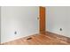 This bedroom features hardwood floors, neutral walls and a closet door with brushed-gold hardware at 114 Catawba Woods Ct, Belmont, NC 28012