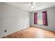 Bright bedroom features hardwood floors, a ceiling fan, and natural light from the window at 114 Catawba Woods Ct, Belmont, NC 28012