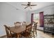 Inviting dining area with wood table, ceiling fan, and view to the outside at 114 Catawba Woods Ct, Belmont, NC 28012