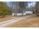 Exterior home view featuring long driveway and fenced-in backyard at 114 Catawba Woods Ct, Belmont, NC 28012