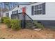 Low angle of the front of a well-kept home showing painted foundation, steps, and a vibrant red door at 114 Catawba Woods Ct, Belmont, NC 28012