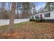 A well-manicured front yard featuring a white picket fence and a charming home with an American flag at 114 Catawba Woods Ct, Belmont, NC 28012