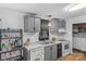 Compact kitchen with gray cabinets, white appliances, and marble-look countertops at 114 Catawba Woods Ct, Belmont, NC 28012