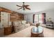 Comfortable living room with wood accent wall, ceiling fan, and ample seating at 114 Catawba Woods Ct, Belmont, NC 28012