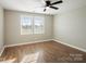 Well-lit bedroom featuring hardwood floors and ceiling fan at 114 E 5Th Ave, Gastonia, NC 28052