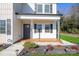 Covered front porch with wood flooring and gray door at 114 E 5Th Ave, Gastonia, NC 28052