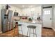 Kitchen with white cabinets, granite counters, and island with seating at 114 E 5Th Ave, Gastonia, NC 28052