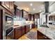 Gourmet kitchen with dark wood cabinets, granite counters, and high-end appliances at 1221 Brunson Rd, Fort Lawn, SC 29714