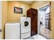 Bright laundry room with washer, dryer, and storage cabinet at 1221 Brunson Rd, Fort Lawn, SC 29714