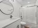 Basement bathroom with a white vanity, round mirror, and shower at 124 Lyman Oak Ct, Fort Mill, SC 29715