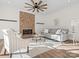 Living room with brick fireplace and ceiling fan at 124 Lyman Oak Ct, Fort Mill, SC 29715