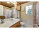 Clean bathroom with single sink vanity, shower/tub combo, and window at 129 Bald Cypress Ln, Mooresville, NC 28115