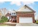 Brick home with a white garage door and landscaping at 129 Bald Cypress Ln, Mooresville, NC 28115