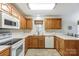 Kitchen with wood cabinets, white appliances and corner sink at 129 Bald Cypress Ln, Mooresville, NC 28115