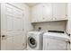 Laundry room with washer, dryer, and cabinets at 129 Bald Cypress Ln, Mooresville, NC 28115