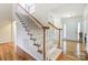 Elegant staircase with white railing and hardwood floors at 129 Bald Cypress Ln, Mooresville, NC 28115