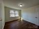 Sunlit bedroom featuring wood-look floors, a bright window, and a minimalist design at 1325 Eastview Ext, Shelby, NC 28152