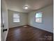 Cozy bedroom with two bright windows, wood flooring, and neutral wall color at 1325 Eastview Ext, Shelby, NC 28152