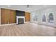 Spacious living room featuring a fireplace and wood accent wall at 13833 Jonathans Ridge Rd, Mint Hill, NC 28227