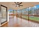 Relaxing screened porch with wood floors and ceiling fan at 13833 Jonathans Ridge Rd, Charlotte, NC 28227