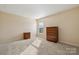 Bright bedroom with neutral walls, carpeting, and ample closet space at 1411 Ladora Dr, Charlotte, NC 28262