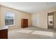 Spacious bedroom with double doors leading to a large closet and neutral decor at 1411 Ladora Dr, Charlotte, NC 28262