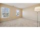 Well-lit bedroom with two windows and carpet at 1411 Ladora Dr, Charlotte, NC 28262