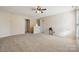 Large bonus room with carpeted floors and ceiling fan at 1411 Ladora Dr, Charlotte, NC 28262