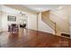 Hardwood floor dining room with adjacent living room and staircase at 1411 Ladora Dr, Charlotte, NC 28262