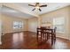 Hardwood floor dining area with an adjacent living room and a ceiling fan at 1411 Ladora Dr, Charlotte, NC 28262