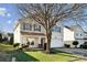 Two-story house with vinyl siding, a brick skirt, and a front yard at 1411 Ladora Dr, Charlotte, NC 28262